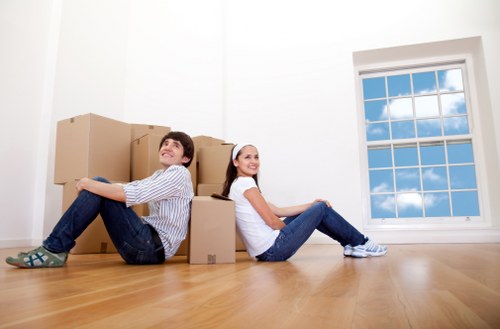 Professional movers handling office equipment