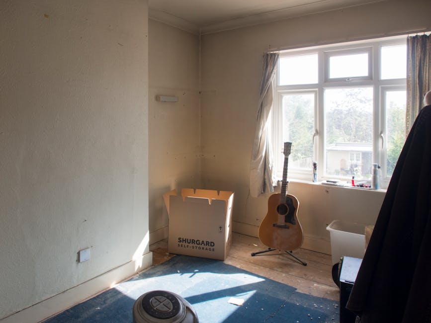Inside a well-lit room of a Victorian flat in Crouch End, a moving process is underway. The room has white walls and a large window with patterned curtains allowing natural light to illuminate the spa